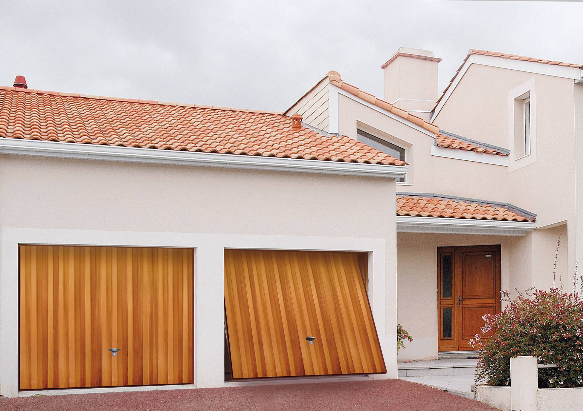 Beautiful house with two garage doors and one of the traditional garage doors is slightly open